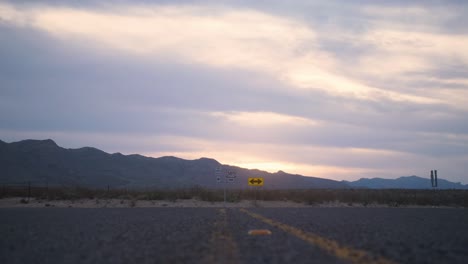 West-Texas-Mountain-Sunset-with-Low-Angle-Slide-across-Highway-4K