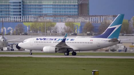Westjet-Boeing-737-Speeding-Down-the-Runway-for-Takeoff,-Tracking
