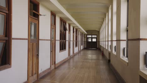 Long-Hallway-in-Empty-School,-Panning-Shot-4k