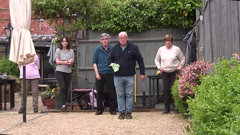 A-pétanque-league-match-being-played-in-a-pub-garden-between-two-teams-from-the-area