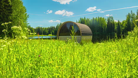 Timelapse-shot-of-an-empty-barrel-sauna-in-rural-countryside-throughout-the-daytime-in-timelapse