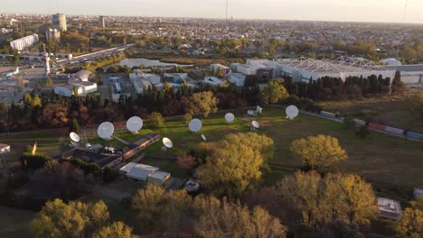 Aerial-view-showing-many-white-circular-antennas-in-research-center-of-Buenos-Aires-during-sunset