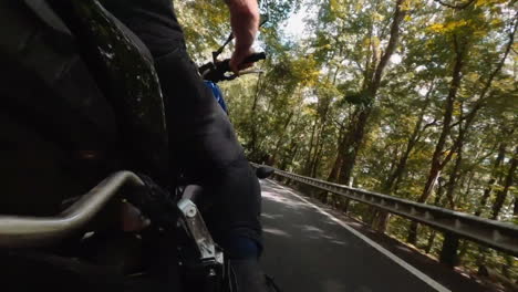 Man-is-driving-a-motorcycle-through-forest-area
