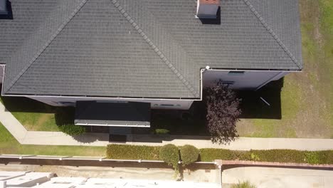 Aerial-drone-shot-flying-above-and-away-from-a-house-in-a-spiral-motion