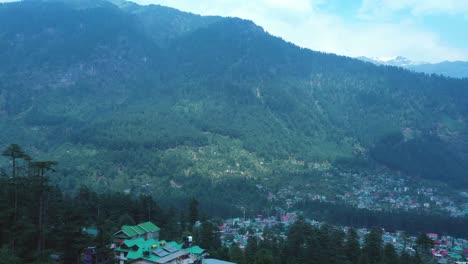 Aerial-view-of-Manali-city-in-India-from-the-Mountain,-Aerial-shot-of-pine-tree-forest-of-Manali