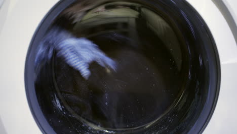 Start-of-a-spin-cycle-in-a-laundry-washing-machine-with-clothing-inside