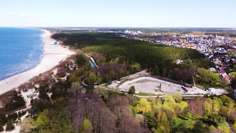 Cityscape-of-Palanga-and-huge-construction-site,-aerial-view
