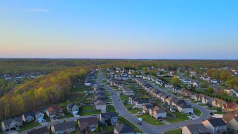 Aerial-fly-through-of-beautiful-suburban-neighborhood-with-blue-skies-at-sunset