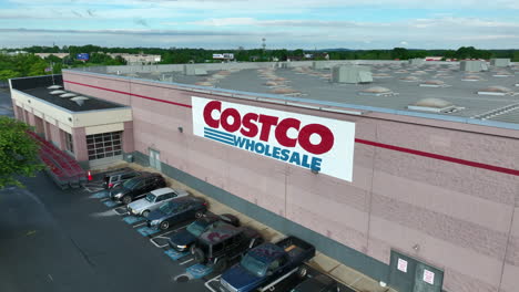 Aerial-pull-back-shot-of-Costco-sign-on-side-of-large-building