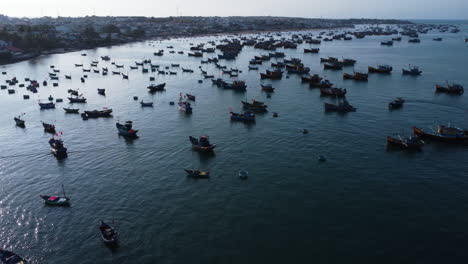 Vista-Aérea-Del-Puerto-Pesquero-De-Mui-Ne-Vietnam-Asia,-Red-De-Pesca-En-Catamarán-Barco-Tradicional,-Drone-Revela-La-Pintoresca-Costa-Del-Pueblo-De-Pescadores