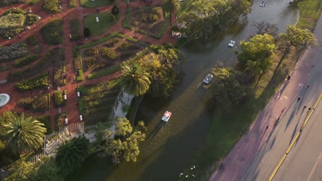 circular-drone-shot-of-the-palermo-lakes-with-pedal-boats-passing-in-buenos-aires-argentina