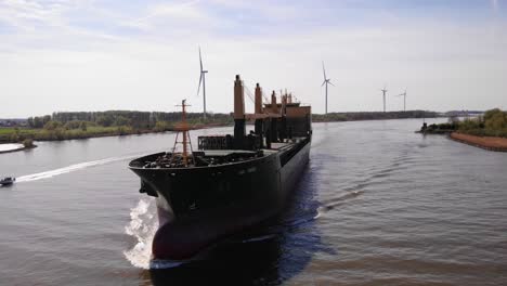 Aerial-Circle-Dolly-Around-Forward-Bow-Of-Aal-Paris-Cargo-Ship-Travelling-Along-Oude-Maas-On-Sunny-Day