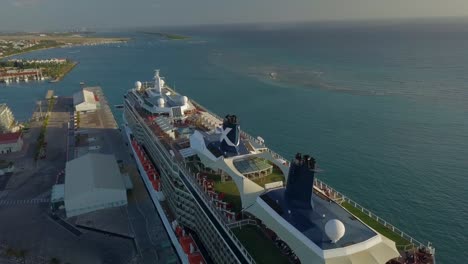 Aerial-overview-of-the-cruise-ship-in-dock-with-a-pan-movement-over-the-cruise-ships-upper-deck-4K