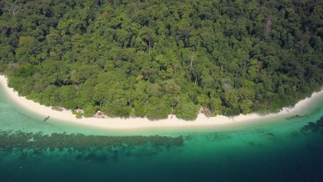 Aerial-view-of-lush-island-with-sandy-beach-in-Thailand---camera-pedestal-down-and-tracking