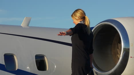 A-playful-flight-attendant-walks-on-the-wing-of-an-aircraft