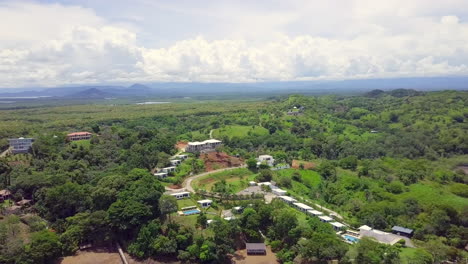 Aerial-drone-shot-of-resort-in-Boca,-Chica,-Panama-with-beautiful-forest,-sky-and-mountain-background