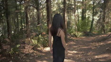 Attractive-Black-hair-asian-woman-smiling-and-turn-around-as-walking-in-forest,-Slowmo