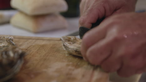 Hands-shucking-oyster-with-knife