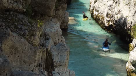 Two-kayakers-training-in-a-river-valley-slow-zoom-out