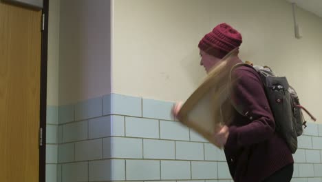 Female-College-Student-Smashes-Painting-Against-Wall-Angrily