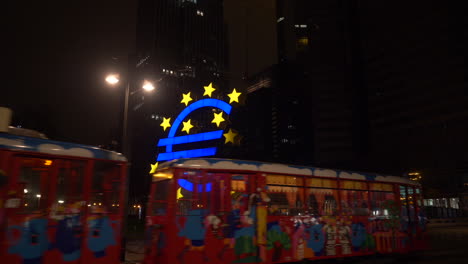Colorfull-tram-driving-past-the-european-central-bank-at-night