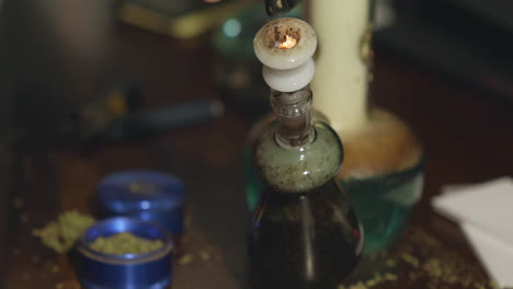 Medical-cannabis-being-lit-and-smoked-through-a-dirty-water-bong