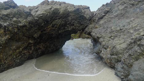 water-passing-through-a-rock-arch-on-the-Victorian-coastline