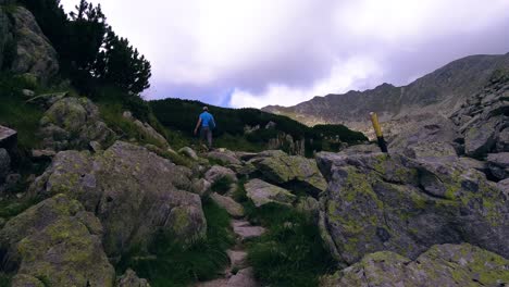 Hikers-walking-up-a-mountain-side-in-the-rocky-mountain-side-of-Romania