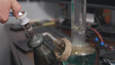 A-large-bong-hit-of-medical-marijuana,-removal-of-the-ash-catcher-and-exhaling-smoke