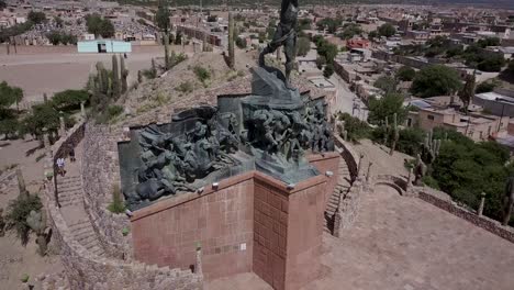 Aerial-shot-of-"Heroes-of-the-Independence"-with-people-visiting-the-monument-on-a-beautiful,-sunny-day