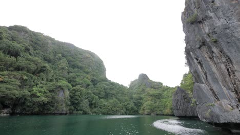 Dolly-shot-sailing-in-the-famous-Big-Lagoon-surrounded-by-limestone-cliffs-in-El-Nido,-Palawan,-the-Philippines