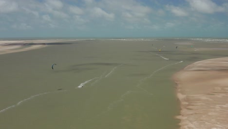 Aerial:-The-lagoon-of-Atins,-Brazil-with-people-kitesurfing