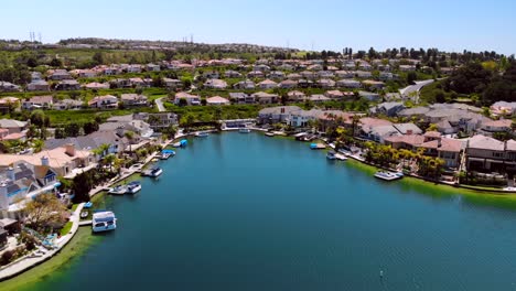 Aerial-drone-flying-into-houses-in-a-cove-on-community-lake-mission-viejo