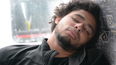 Young-African-American-Black-Man-Sleeps-on-Bus-Chair-Extream-Close-Up