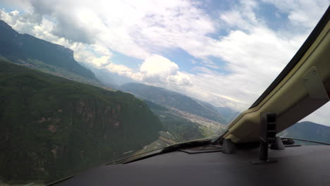 View-from-the-cockpit-of-a-corporate-jet-circling-for-landing-in-a-small-valley-in-the-Italian-Alps