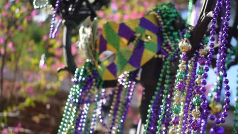 Outdoor-Mardi-Gras-beads-and-mask-on-light-post-in-sunshine