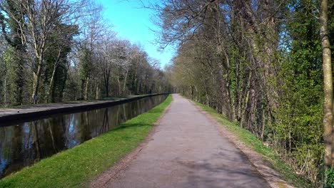 Walking-along-the-path-at-the-famous-Pontcysyllte-Aqueduct-on-the-Llangollen-canal-route-in-the-beautiful-Welsh-countryside