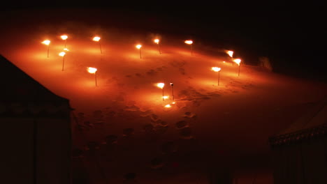 A-heart-formed-by-torches-in-the-night,-in-the-Sahara-desert-near-Merzouga,-Morocco