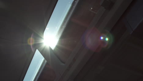 Lens-flare-shining-through-rooftop-of-train-window