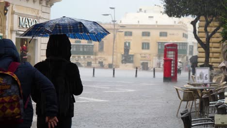 People-experiencing-the-summer-rain-at-Valletta-Malta-circa-March-2019