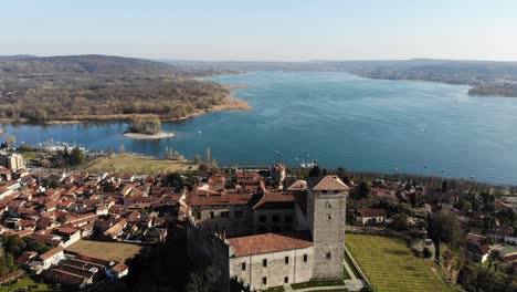 A-mavic-air-drone-is-moving-forward-Rocca-di-Angera-revealing-the-beautiful-lake-landscape-on-a-sunny-day