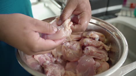 Close-up-of-raw-chicken-being-peeled