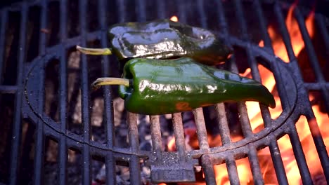 poblano-peppers-on-outdoor-grill-closeup-showing-flames-and-smoke-with-copy-space