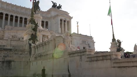 Panning-shot-infront-of-the-Monumento-a-Vittorio-Emanuele-II-at-a-sunny-day-in-the-inner-city-of-Rome,-Italy
