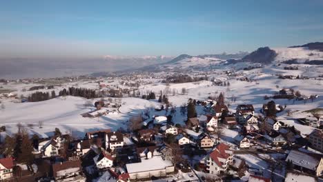 Flight-over-a-small-village-in-Switzerland-while-winter