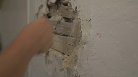 Fists-punching-plastered-wall.-slow-motion,-CLOSE-UP