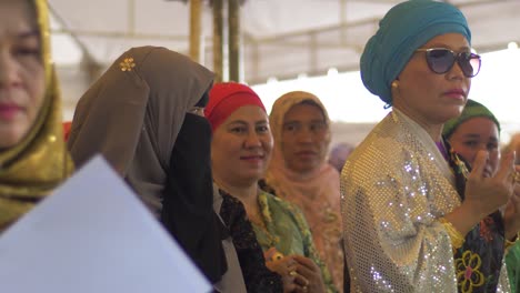 Muslim-women-in-brightly-colored-and-decorated-clothes-gather-at-an-event-celebrating-National-Women's-Month-in-the-Philippines