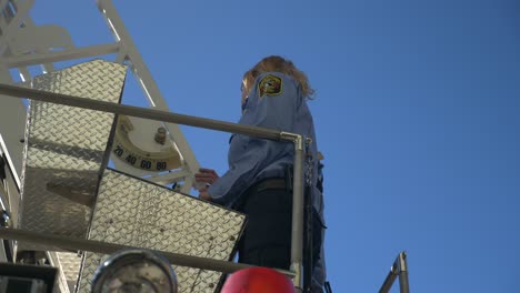 Firefighters-operator-a-long-rescue-ladder-on-top-of-a-fire-truck