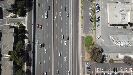 Top-down-pan-up-view-of-highway-traffic-on-101-roof-top-solar-panels-zoom-out