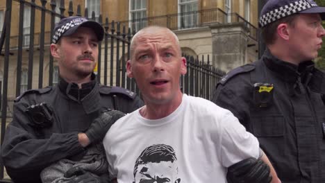 A-Tommy-Robinson-supporter-is-arrested-by-police-along-Whitehall,-London